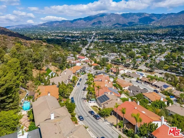an aerial view of residential house with outdoor space and mountain view