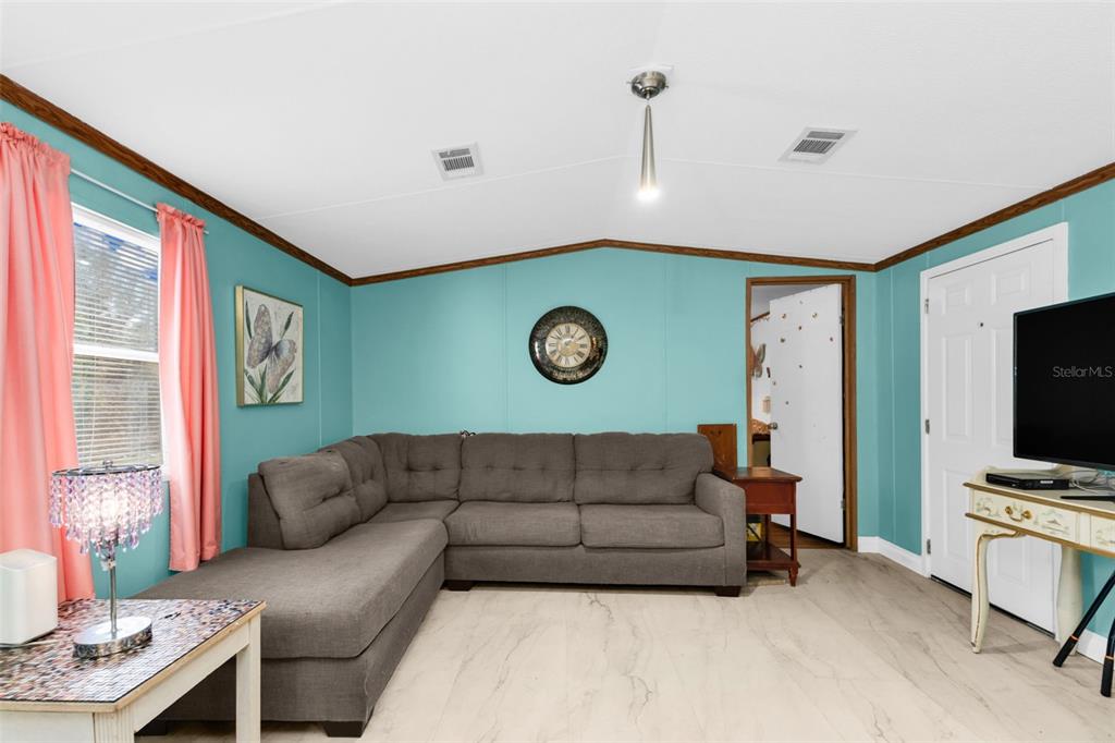 6128 Padula Street Punta Gorda, FL 33950 - Photo 4 of 24 a living room with furniture and a flat screen tv