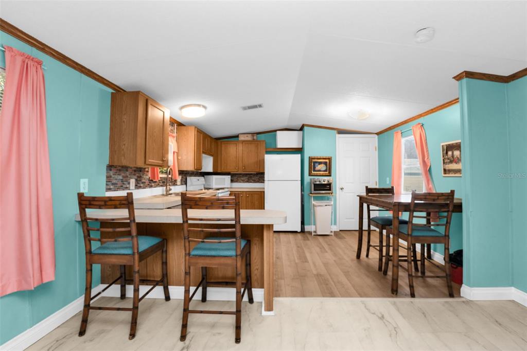 6128 Padula Street Punta Gorda, FL 33950 - Photo 6 of 24 a dining room with furniture and wooden floor