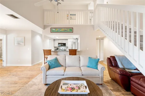 a living room with furniture and wooden floor