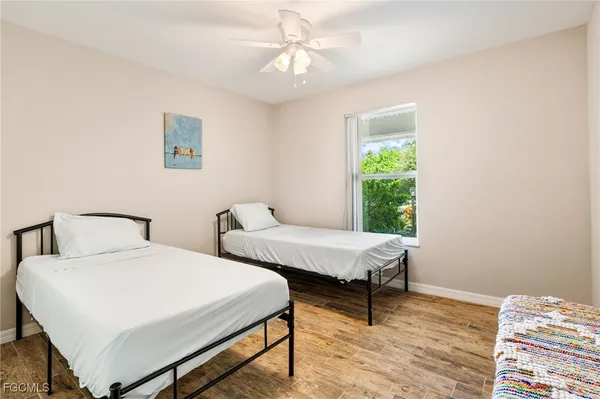 a bedroom with two beds and a window