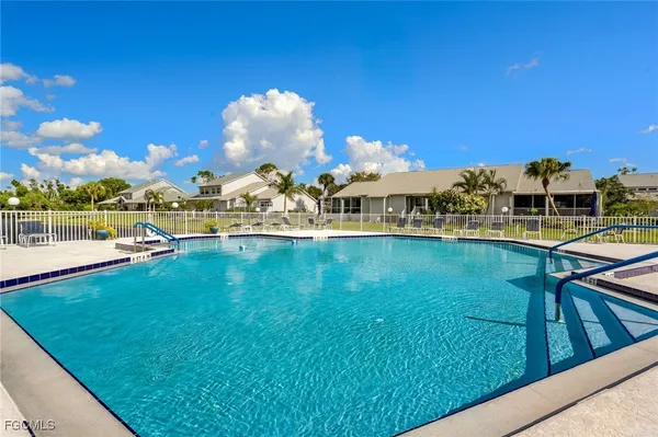 a view of a swimming pool with an outdoor seating and kitchen view