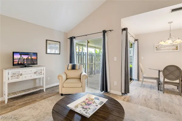 a living room with furniture a rug and a flat screen tv