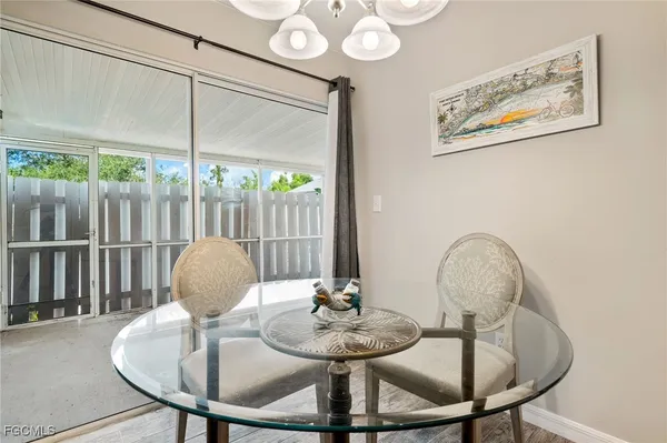 a view of a dining room with furniture wooden floor and a chandelier