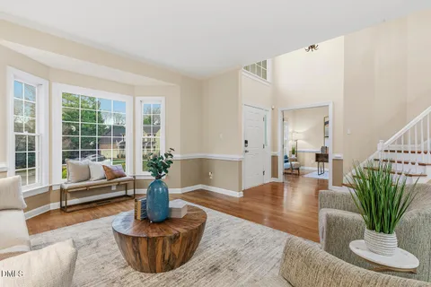 a view of a dining room with furniture a chandelier and wooden floor