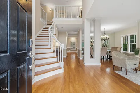 a view of a hallway view with wooden floor and staircase