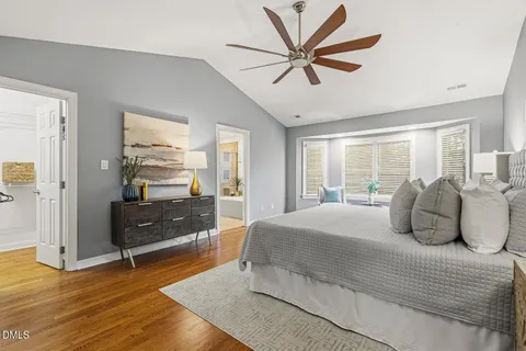 a view of backyard with wooden fence and large trees