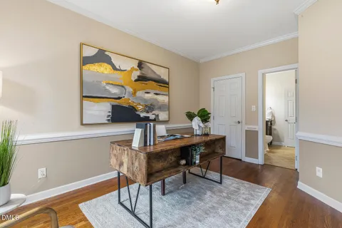 a dining room with furniture a rug and wooden floor