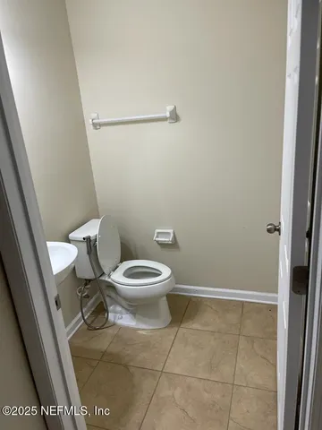 a white toilet sitting next to a white sink
