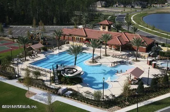 a swimming pool with outdoor seating and yard