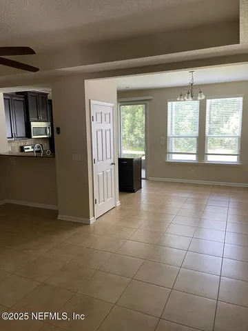 a view of a kitchen with an empty space and a window