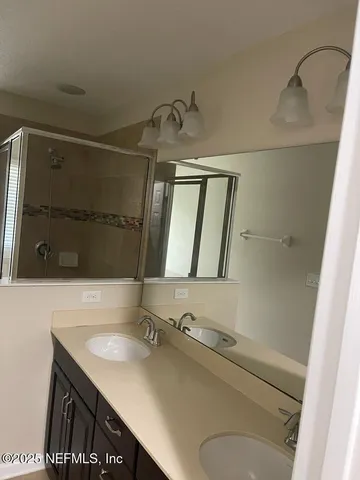 a bathroom with a granite countertop sink toilet and mirror