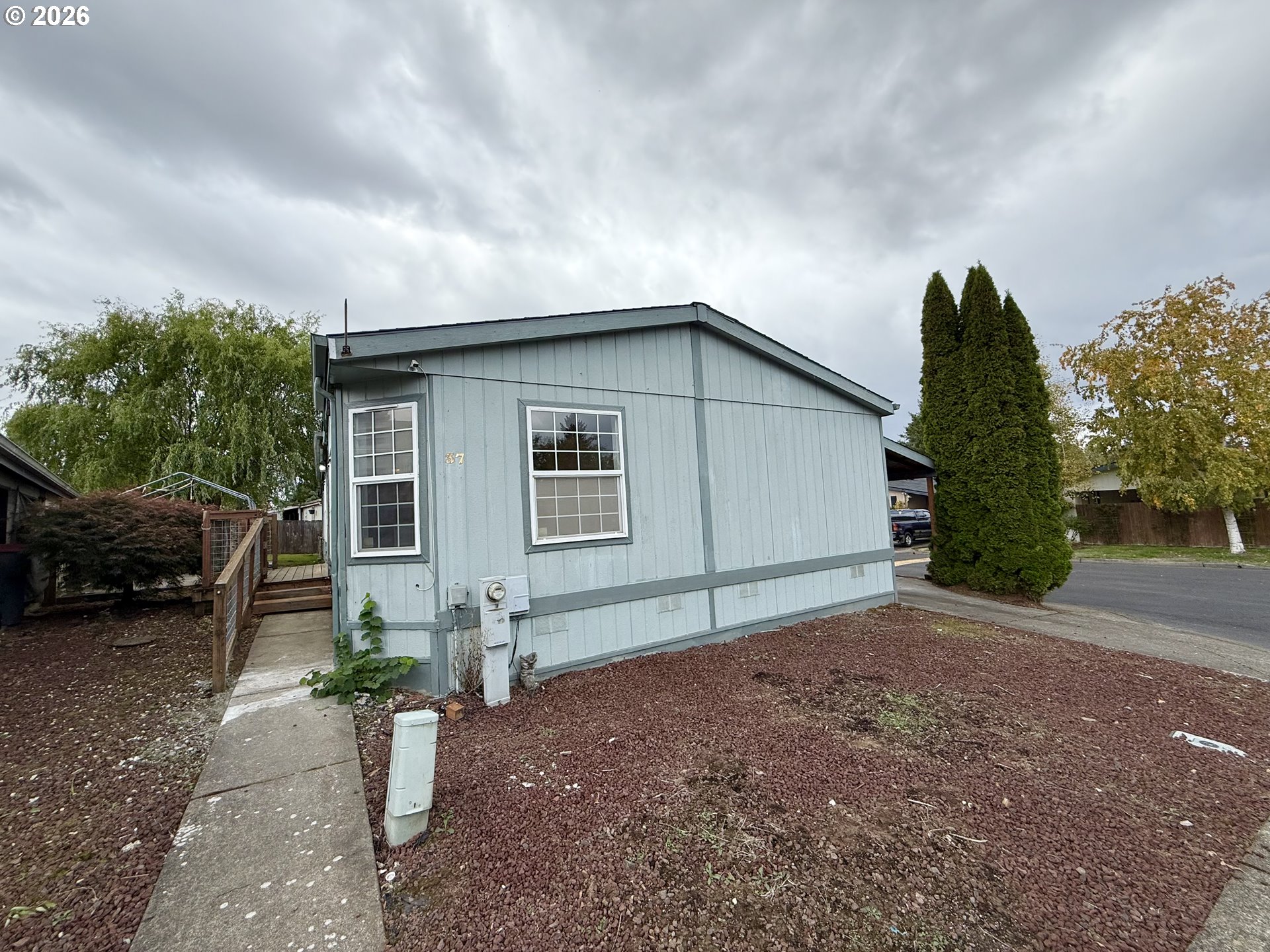 1282 3rd Street, Unit 37 Lafayette, OR 97127 - Photo 26 of 28 a backyard of a house with plants and trees