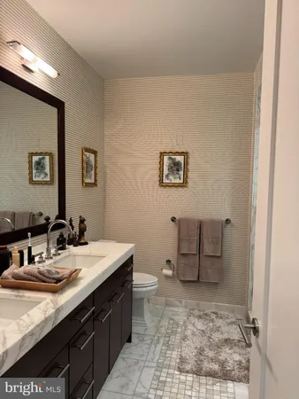 a bathroom with a sink a toilet and mirror