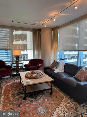 a living room with furniture and a large window
