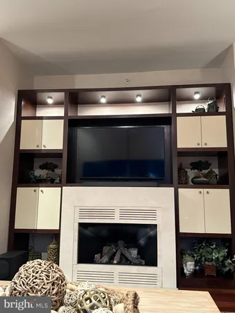 a living room with a fireplace and a flat screen tv