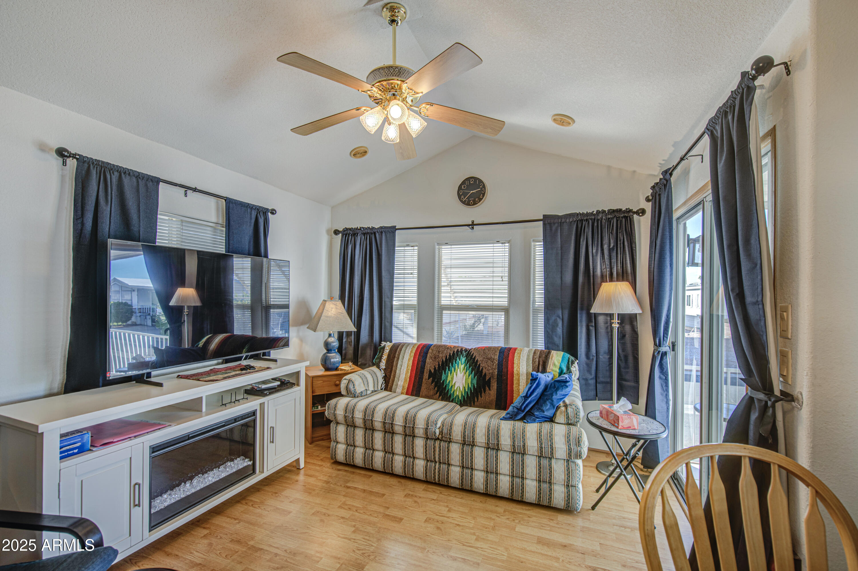 7750 East Broadway Road, Unit 250 Mesa, AZ 85208 - Photo 11 of 35 a living room with furniture and a flat screen tv