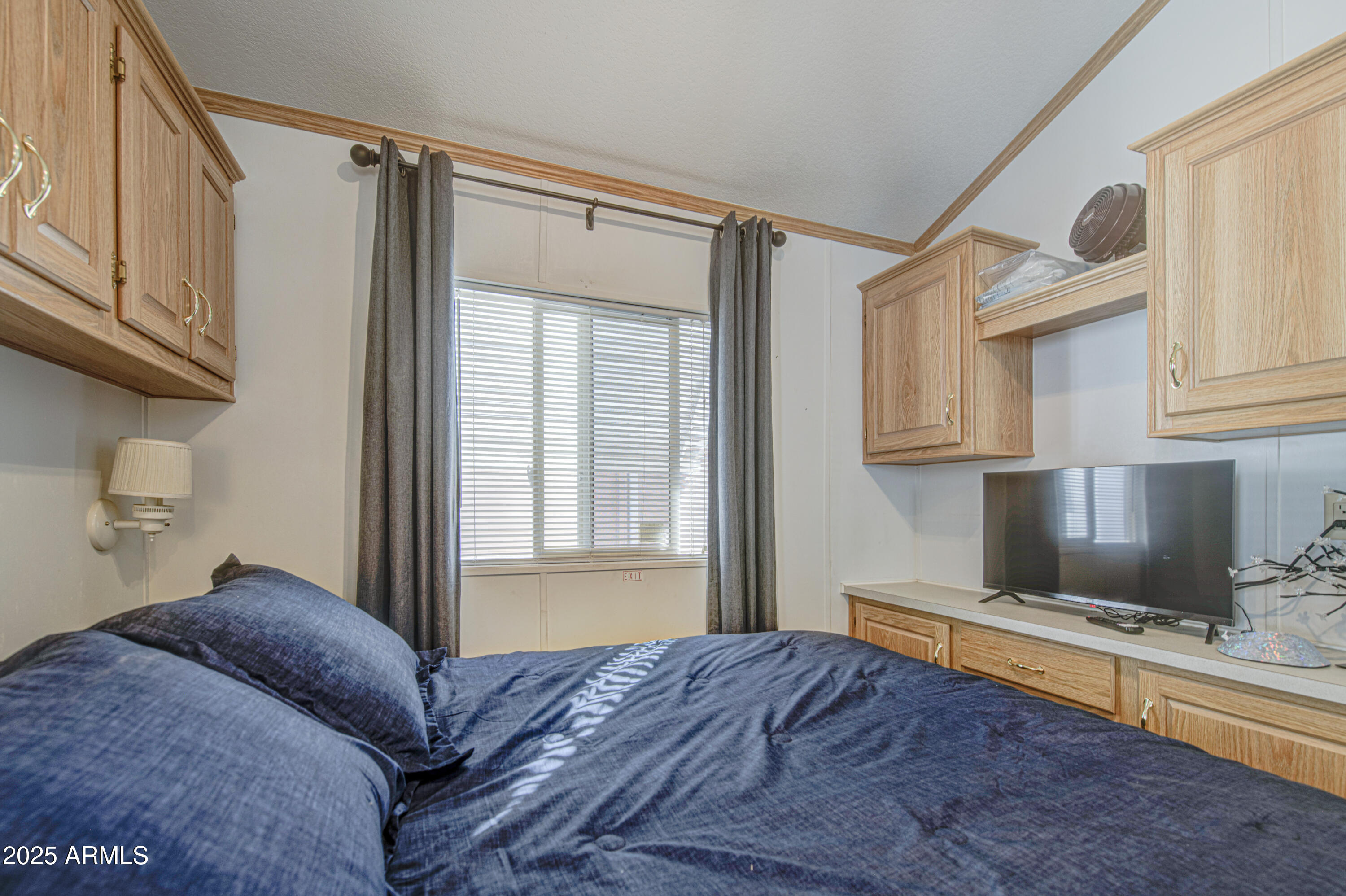 7750 East Broadway Road, Unit 250 Mesa, AZ 85208 - Photo 13 of 35 a bedroom with a bed window and flowerpot
