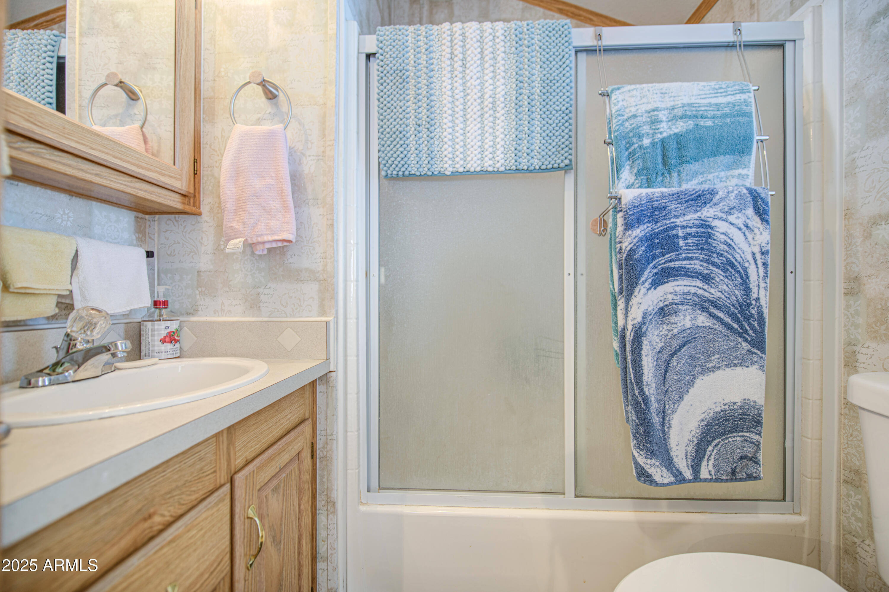 7750 East Broadway Road, Unit 250 Mesa, AZ 85208 - Photo 15 of 35 a bathroom with a sink a mirror and a bathtub