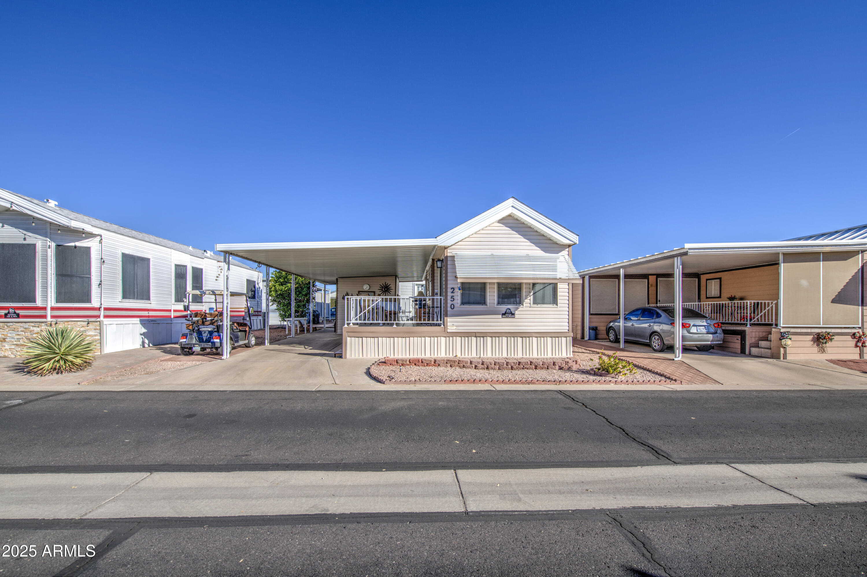 7750 East Broadway Road, Unit 250 Mesa, AZ 85208 - Photo 18 of 35 a front view of a house with a yard