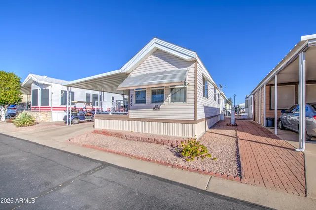 a patio with a table and chairs under an umbrella