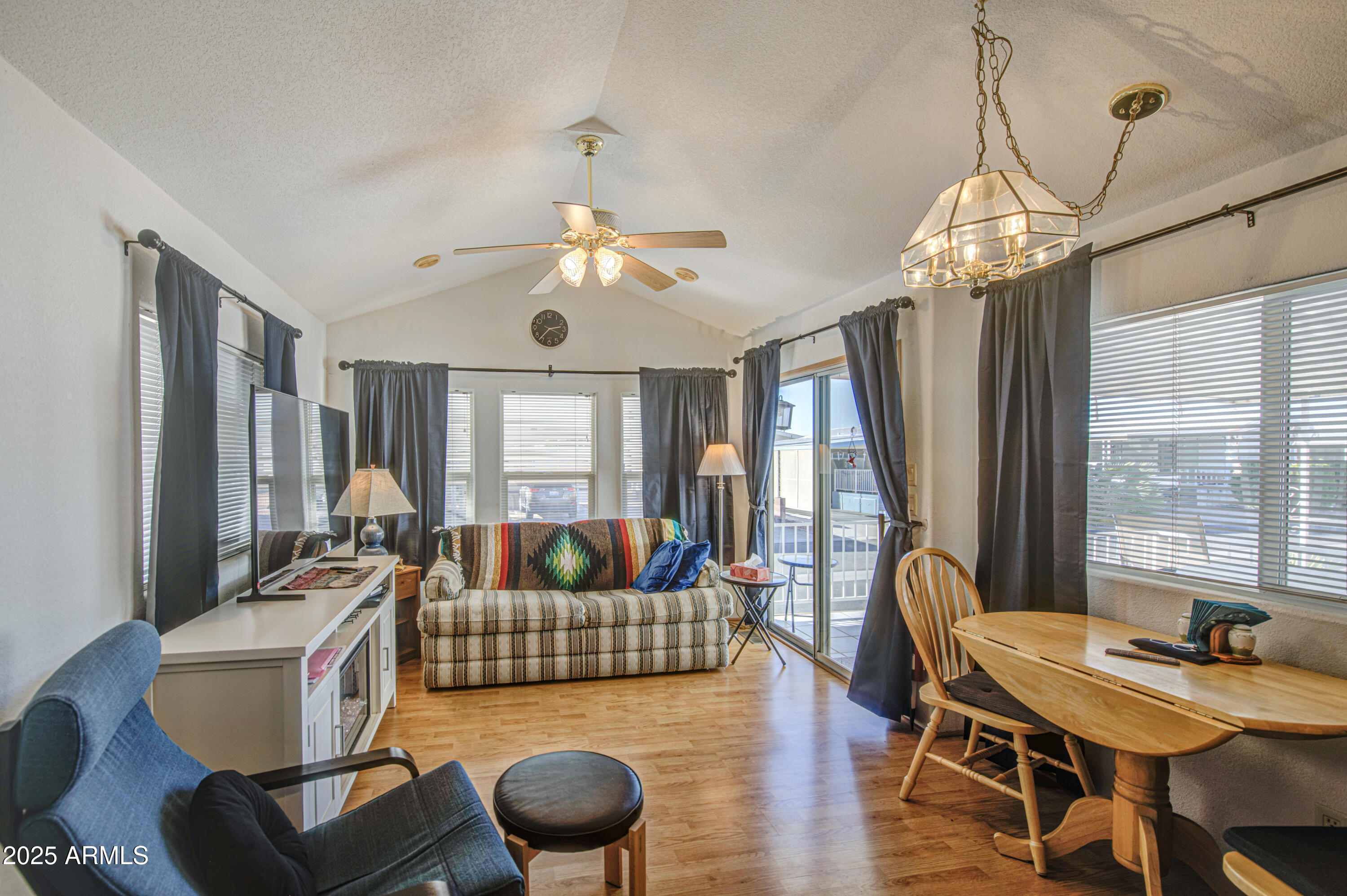 7750 East Broadway Road, Unit 250 Mesa, AZ 85208 - Photo 3 of 35 a living room with furniture chandelier and a large window