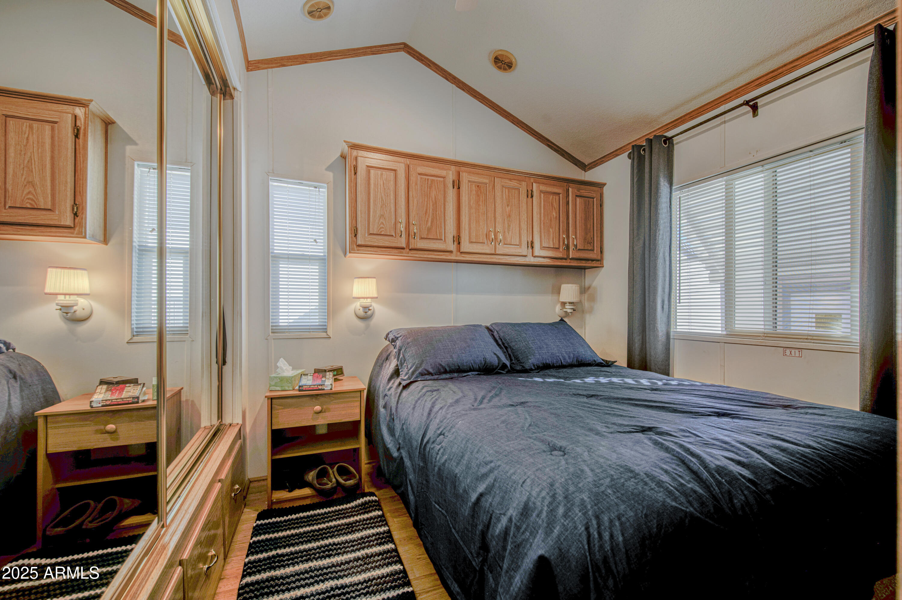 7750 East Broadway Road, Unit 250 Mesa, AZ 85208 - Photo 4 of 35 a bedroom with a bed and wooden floor