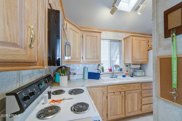 a kitchen with a sink a stove and cabinets