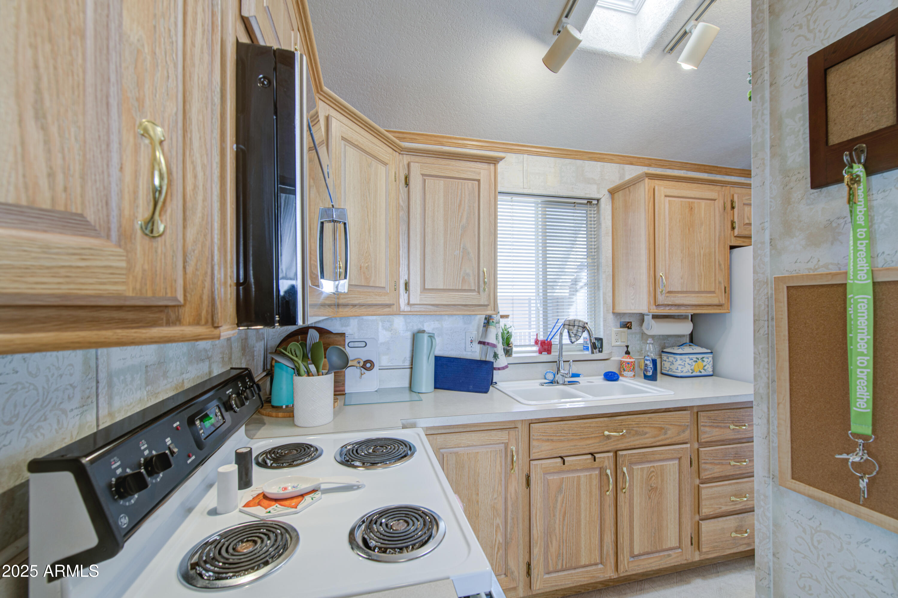 7750 East Broadway Road, Unit 250 Mesa, AZ 85208 - Photo 8 of 35 a kitchen with sink a stove and cabinets