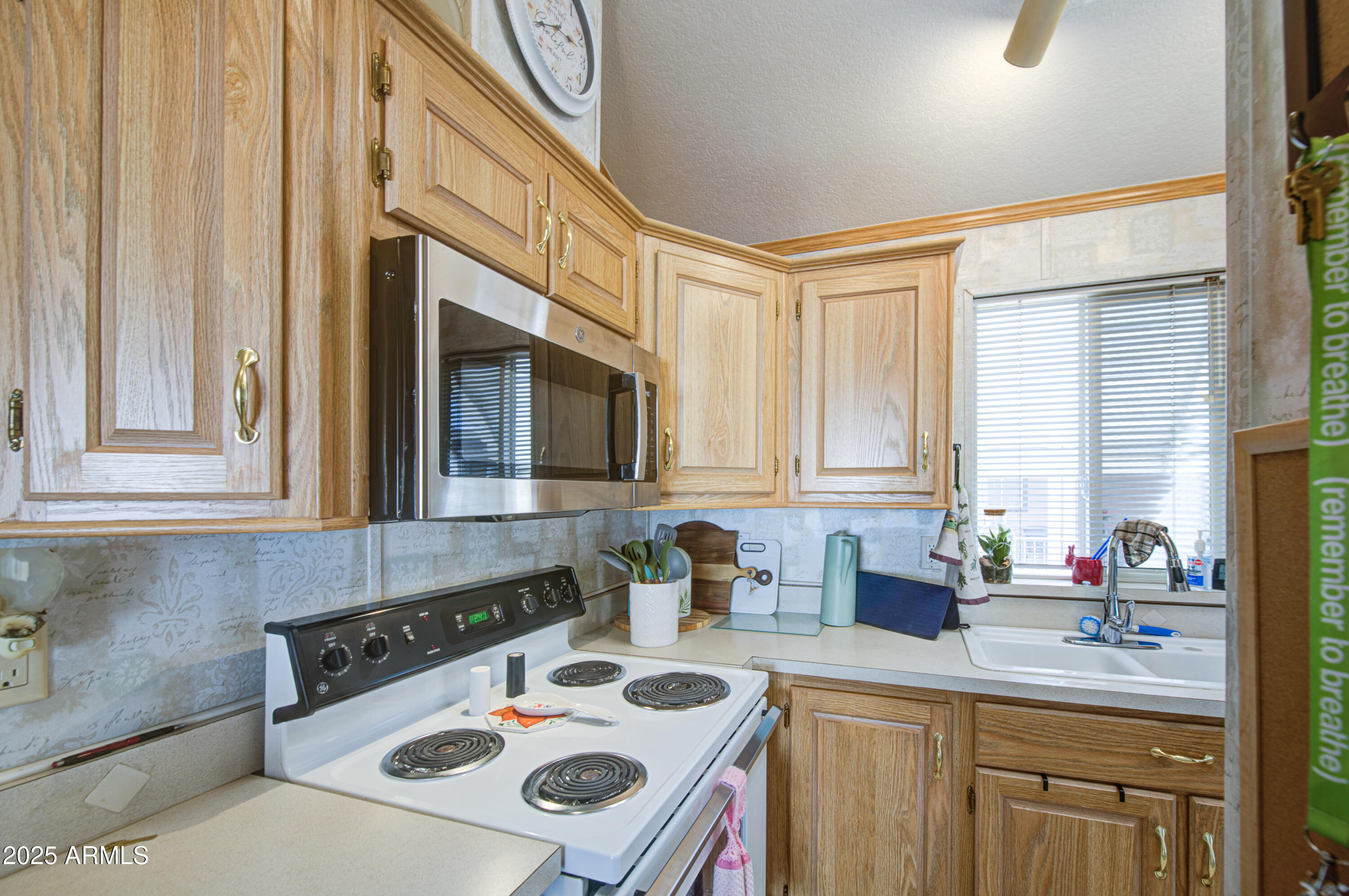 7750 East Broadway Road, Unit 250 Mesa, AZ 85208 - Photo 9 of 35 a kitchen with a sink stove and cabinets