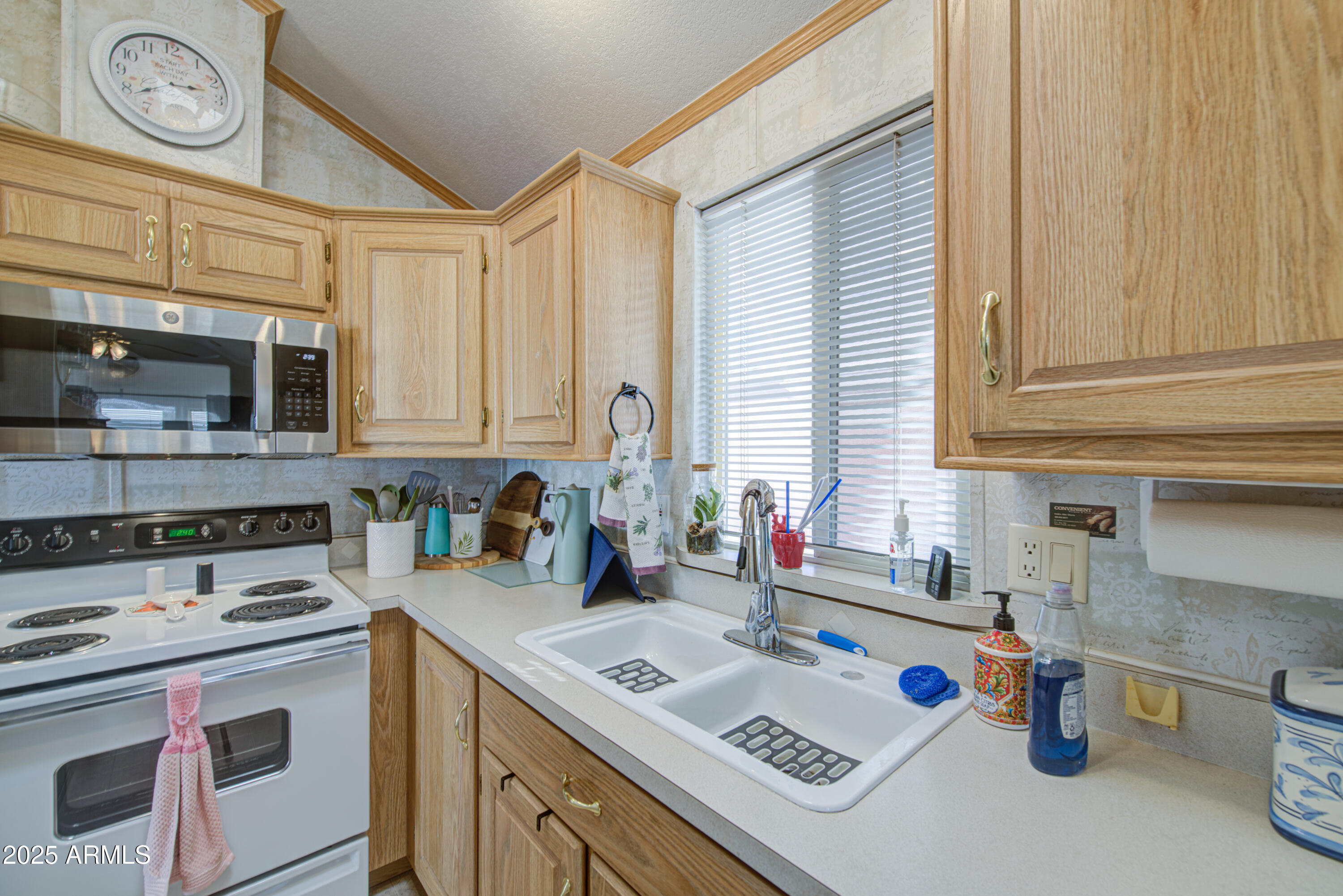 7750 East Broadway Road, Unit 250 Mesa, AZ 85208 - Photo 10 of 35 a kitchen with a sink a stove and cabinets