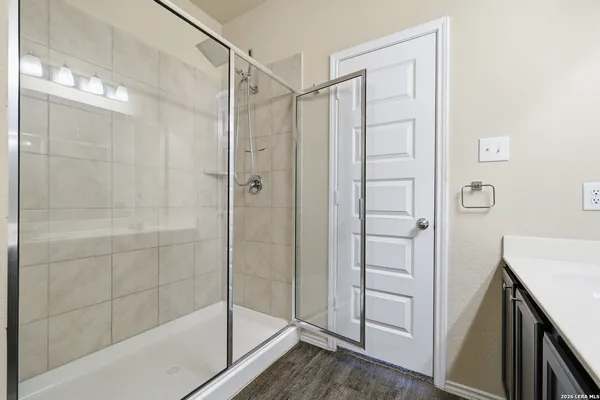 a bathroom with a shower and a sink