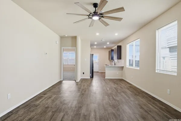 a view of an empty room with a kitchen