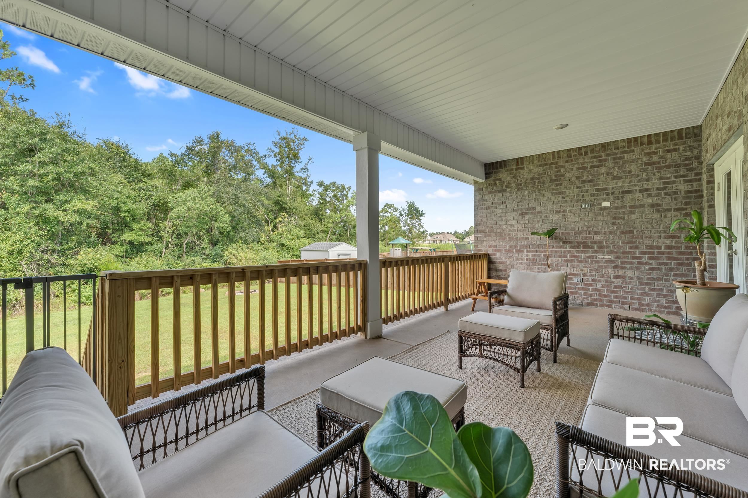 8774 Primland Boulevard Foley, AL 36535 - Photo 39 of 49 Wooden deck with outdoor lounge area, a patio, and a yard