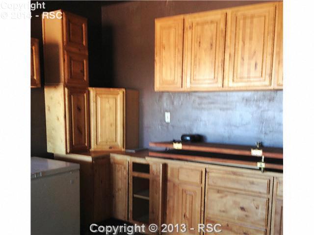 7950 Mulberry Road Calhan, CO 80808 - Photo 20 of 25 Even the garage workshop sports custom cabinets.