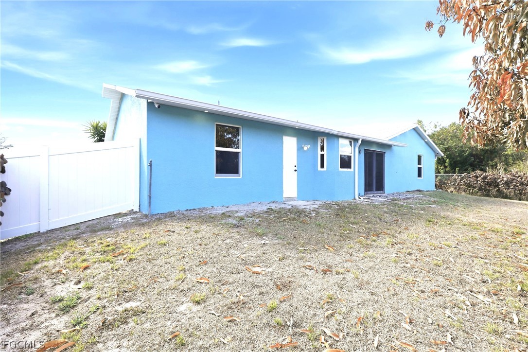 3404 2nd Street Southwest Lehigh Acres, FL 33976 - Photo 2 of 41 a view of a house with a yard