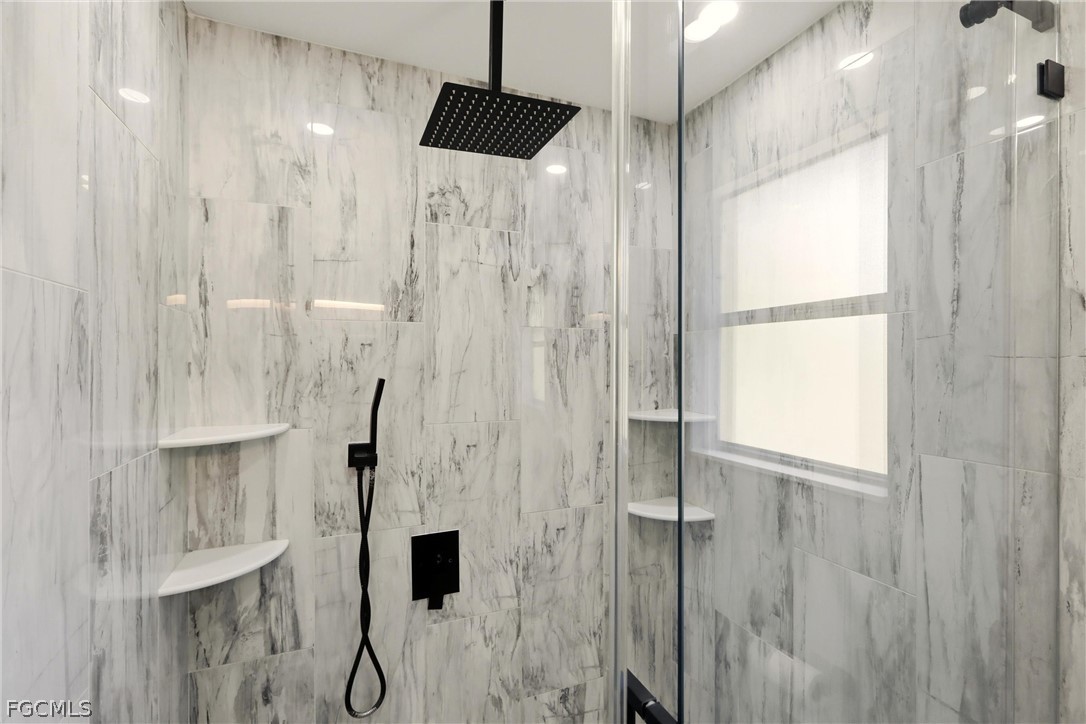 3404 2nd Street Southwest Lehigh Acres, FL 33976 - Photo 21 of 41 a bathroom with a shower and a glass door