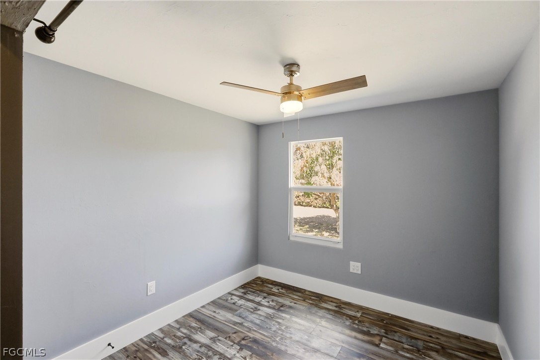 3404 2nd Street Southwest Lehigh Acres, FL 33976 - Photo 25 of 41 an empty room with windows and fan