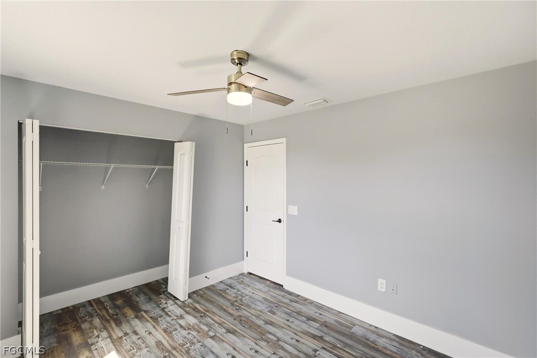 3404 2nd Street Southwest Lehigh Acres, FL 33976 - Photo 30 of 41 a view of an empty room with wooden floor