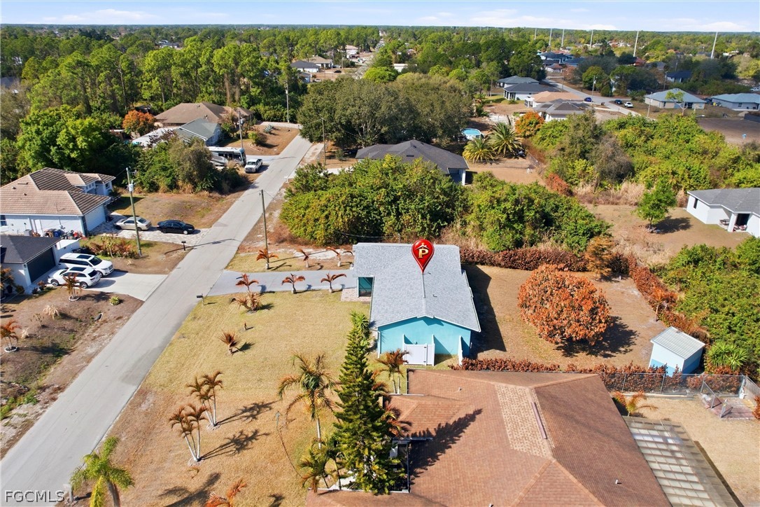 3404 2nd Street Southwest Lehigh Acres, FL 33976 - Photo 36 of 41 an aerial view of a house with a garden