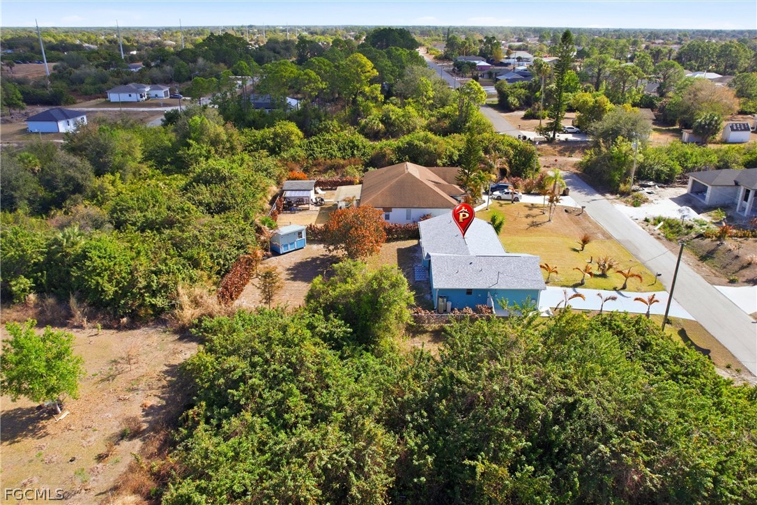 3404 2nd Street Southwest Lehigh Acres, FL 33976 - Photo 39 of 41 an aerial view of a house with a yard and lake view