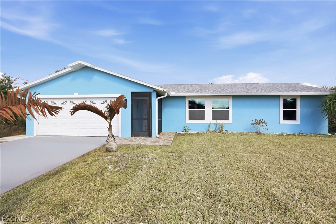 3404 2nd Street Southwest Lehigh Acres, FL 33976 - Photo 5 of 41 a front view of a house with a yard