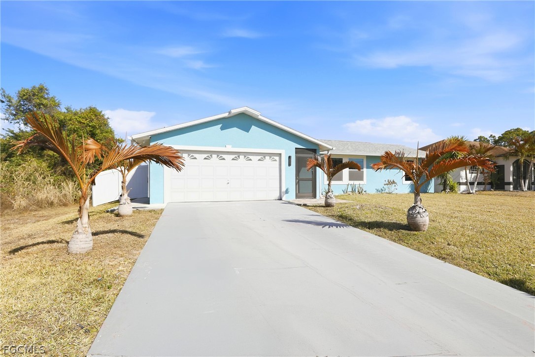 3404 2nd Street Southwest Lehigh Acres, FL 33976 - Photo 7 of 41 a view of a house with a yard
