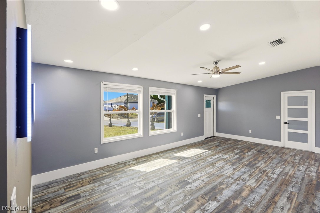 3404 2nd Street Southwest Lehigh Acres, FL 33976 - Photo 10 of 41 a view of an empty room with window and wooden floor