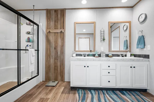 a bathroom with a double vanity sink and mirror