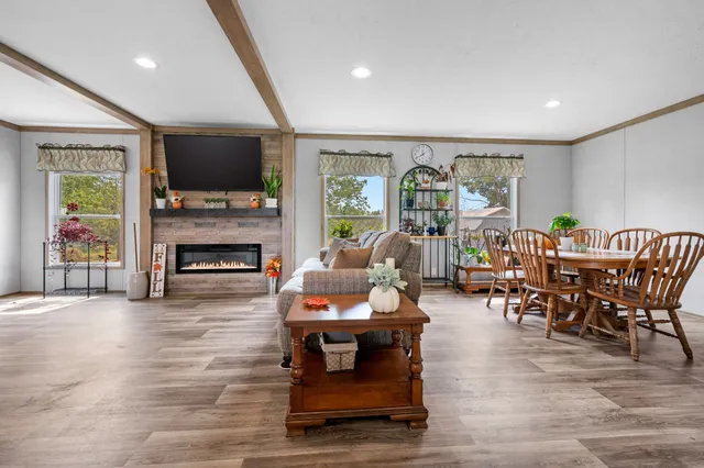 a living room with furniture a flat screen tv and a fireplace