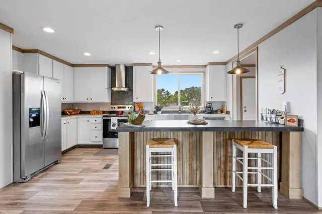a kitchen with a sink refrigerator and cabinets