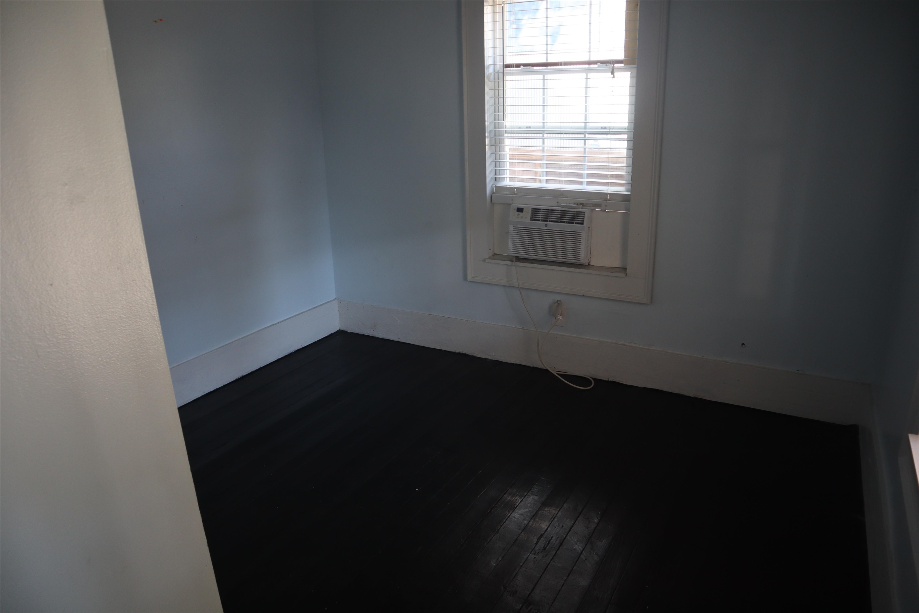 130 Moore Street St. Augustine, FL 32084 - Photo 19 of 27 a view of an empty room with wooden floor and a window