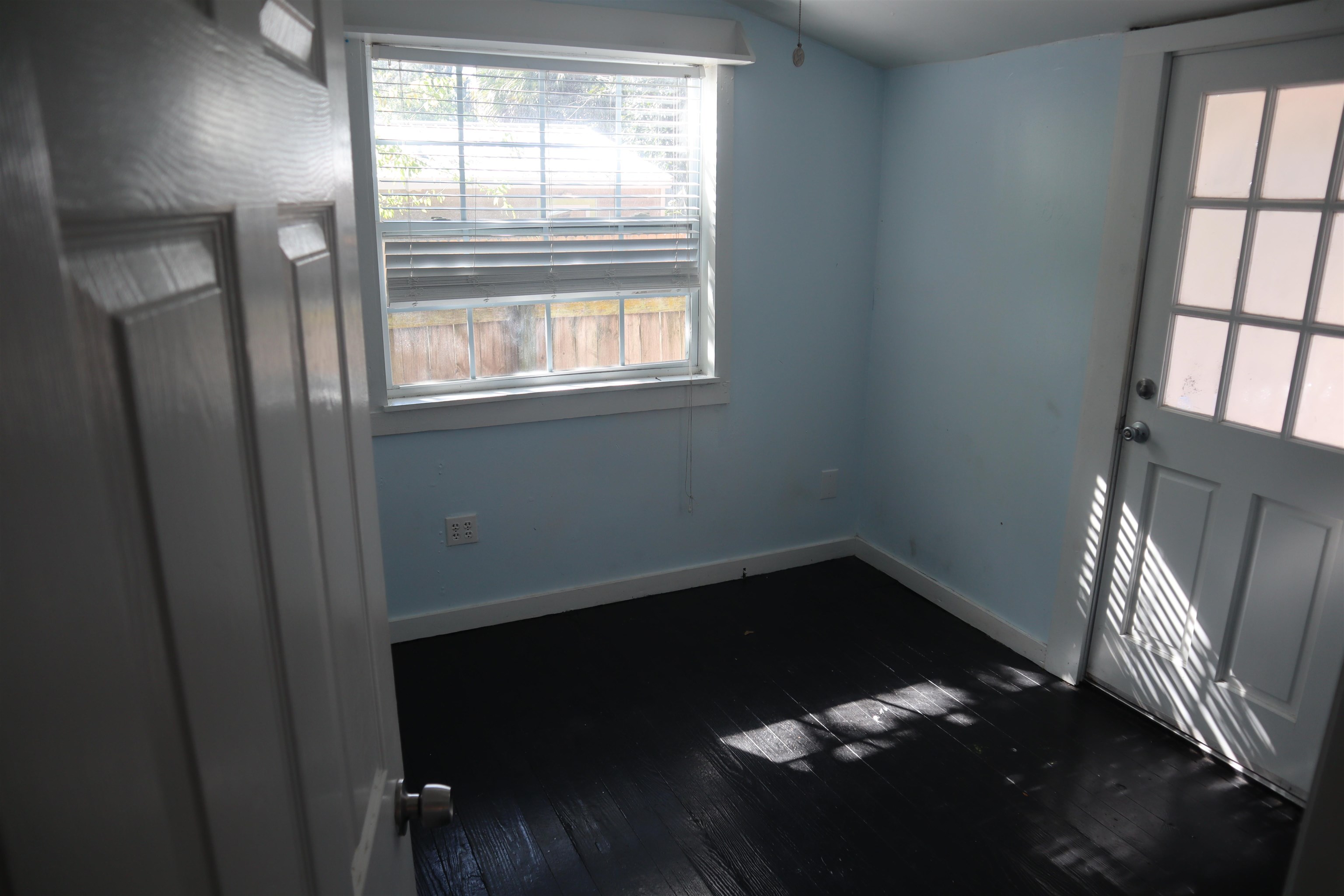 130 Moore Street St. Augustine, FL 32084 - Photo 10 of 27 a view of an empty room with wooden floor and a window