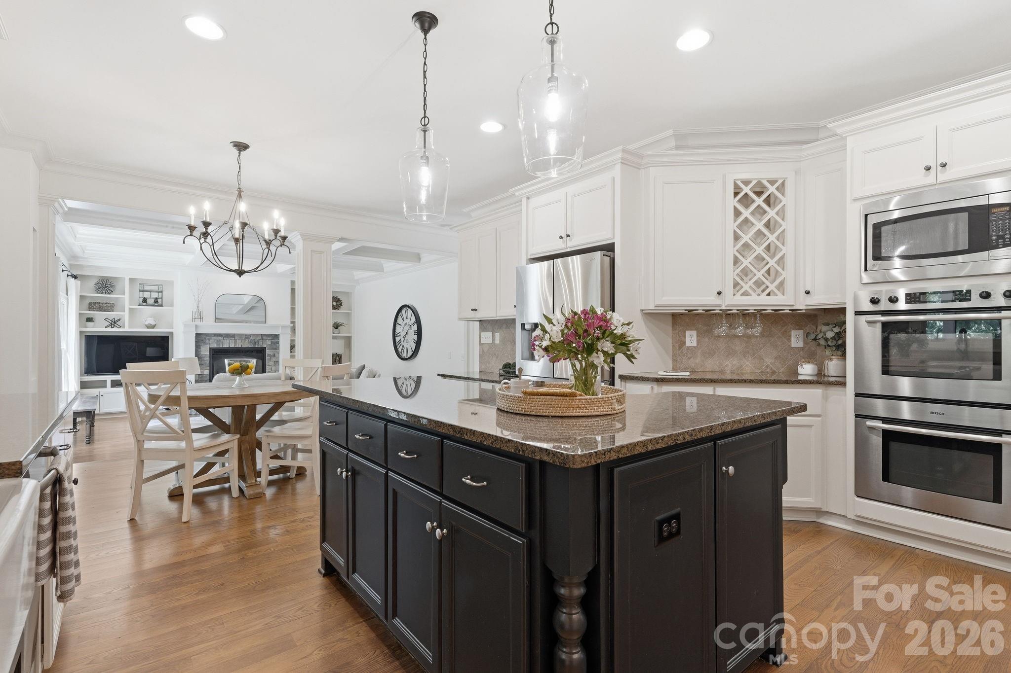 235 Grey Road Davidson, NC 28036 - Photo 5 of 42 a kitchen with cabinets a chandelier and stainless steel appliances